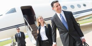 corporate couple disembarking from private jet